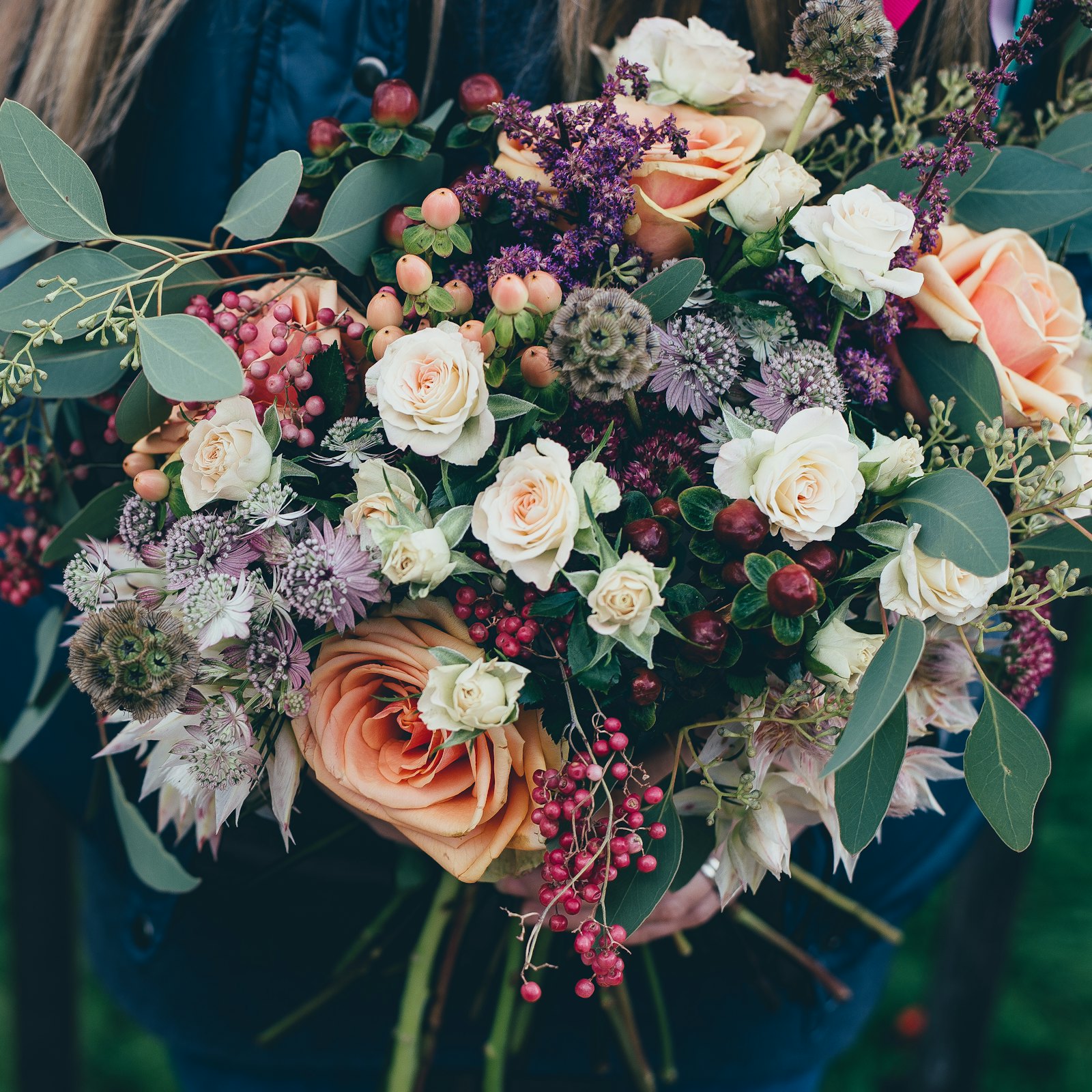 A hand-tied arrangement of garden roses and wild berries